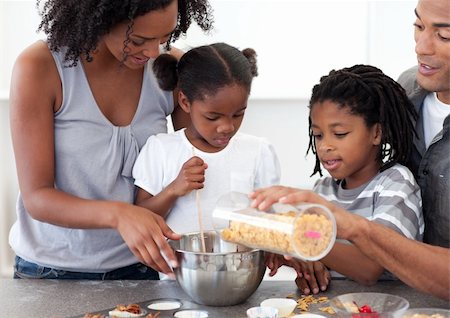 simsearch:400-04151115,k - Ethnic family making biscuits together in the kitchen Foto de stock - Super Valor sin royalties y Suscripción, Código: 400-04192478