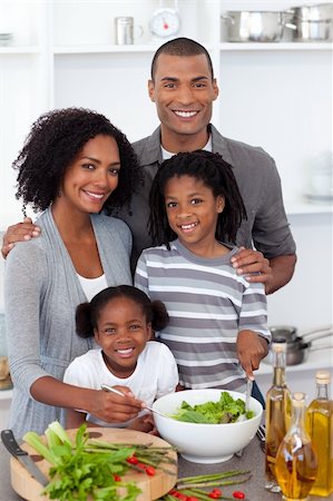 simsearch:400-04206231,k - Ethnic family preparing salad together in the kitchen Stock Photo - Budget Royalty-Free & Subscription, Code: 400-04192489