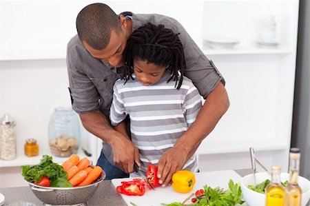 Loving father helping his son cut vegetables in the kitchen Stock Photo - Budget Royalty-Free & Subscription, Code: 400-04192493