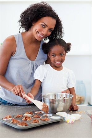 Attentive mother helping her girl cooking biscuits in the kitchen Stock Photo - Budget Royalty-Free & Subscription, Code: 400-04192519