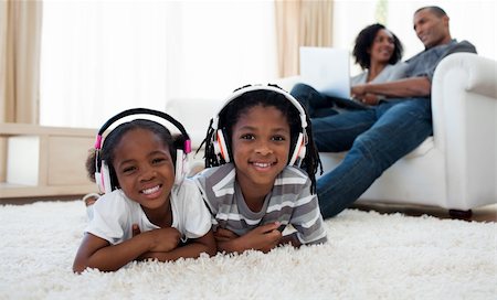 father son indoors - Cute siblings listening music in the living room Photographie de stock - Aubaine LD & Abonnement, Code: 400-04192528