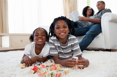 simsearch:400-05246310,k - Brother and sister playing alphabetic cubes lying on the floor Stock Photo - Budget Royalty-Free & Subscription, Code: 400-04192522