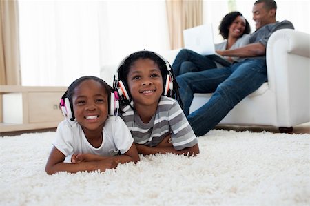 father son indoors - Cute siblings listening music lying on the floor in the living room Photographie de stock - Aubaine LD & Abonnement, Code: 400-04192530