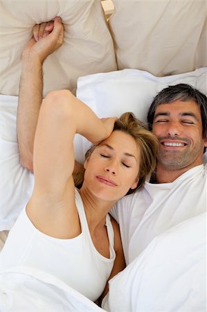 simsearch:400-04326193,k - Beautiful couple waking up  lying in bed Stock Photo - Budget Royalty-Free & Subscription, Code: 400-04193042