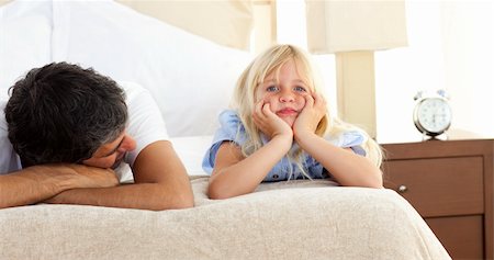 father daughter sad hug - Little girl lying on bed with her father at home Stock Photo - Budget Royalty-Free & Subscription, Code: 400-04193114