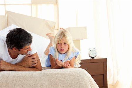 father daughter sad hug - Attentive father talking with his daughter lying on bed Stock Photo - Budget Royalty-Free & Subscription, Code: 400-04193116