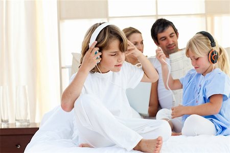 Jolly siblings listening music with headphones at home Stock Photo - Budget Royalty-Free & Subscription, Code: 400-04193130