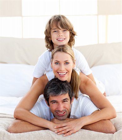 simsearch:400-04192370,k - Little boy and his parents playing lying on the bed Stock Photo - Budget Royalty-Free & Subscription, Code: 400-04193140