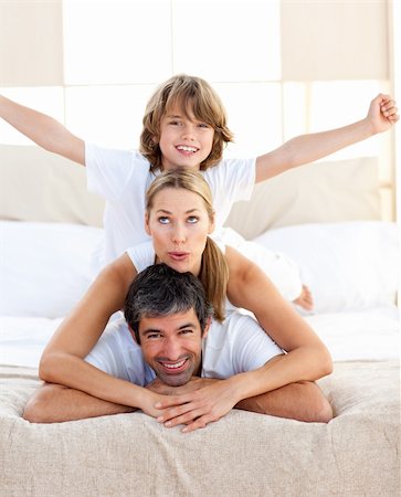 simsearch:400-04193152,k - Cute child and his parents having fun lying on the bed Stockbilder - Microstock & Abonnement, Bildnummer: 400-04193141
