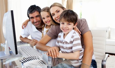 simsearch:400-04044137,k - Portrait of a smiling family at a computer in the living-room Stock Photo - Budget Royalty-Free & Subscription, Code: 400-04193167