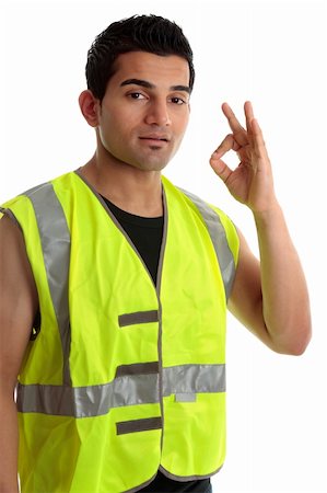 Ethnic mixed race, blue collar man such as a builder, tradesman, labourer, handyman gestures a positive a-ok approval hand sign gesture.  White background. Photographie de stock - Aubaine LD & Abonnement, Code: 400-04193168