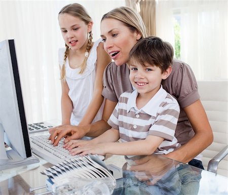 simsearch:400-04044122,k - Happy mother and her children using a computer at home Stock Photo - Budget Royalty-Free & Subscription, Code: 400-04193160