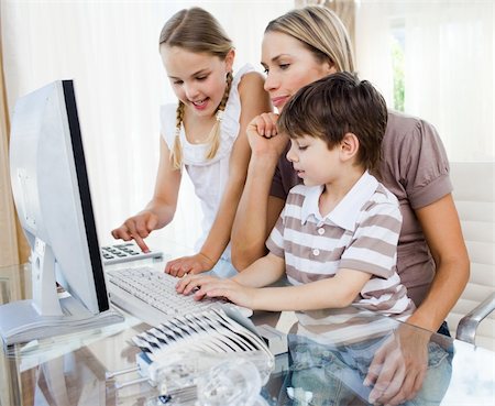 simsearch:400-04044137,k - Attentive mother teaching her children how to use a computer at home Stock Photo - Budget Royalty-Free & Subscription, Code: 400-04193161