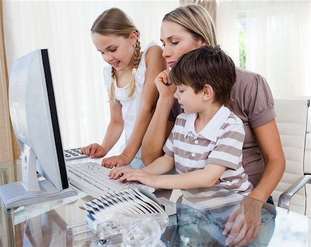 simsearch:400-04044122,k - Attractive mother teaching her children how to use a computer at home Stock Photo - Budget Royalty-Free & Subscription, Code: 400-04193162