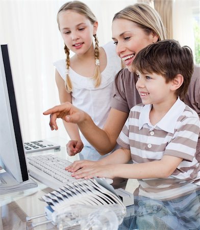 simsearch:400-04044137,k - Happy mother and her children using a computer at home Stock Photo - Budget Royalty-Free & Subscription, Code: 400-04193177