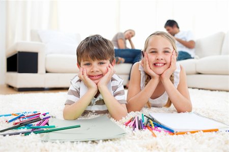 Merry siblings drawing lying on the floor in the living room Stock Photo - Budget Royalty-Free & Subscription, Code: 400-04193275