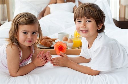 Close-up of cute brother and sister having breakfast with their parents in the bedroom Stock Photo - Budget Royalty-Free & Subscription, Code: 400-04193368