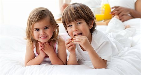 Cute brother and sister having breakfast in the bedroom Stock Photo - Budget Royalty-Free & Subscription, Code: 400-04193377
