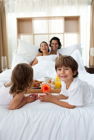 Happy children bringing a breakfast to their parents in the bedroom Stock Photo - Budget Royalty-Free & Subscription, Code: 400-04193371