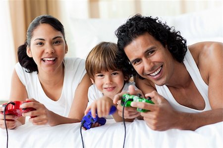 simsearch:400-04157519,k - Boy and his parents playing video games at home Stock Photo - Budget Royalty-Free & Subscription, Code: 400-04193389