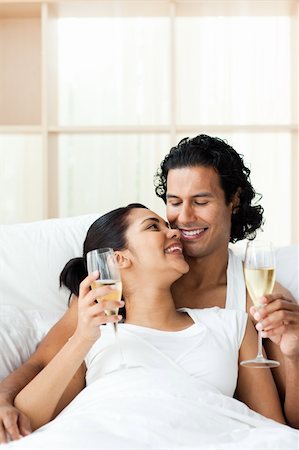 simsearch:400-04150404,k - Lovers drinking Champagne lying on the bed Stock Photo - Budget Royalty-Free & Subscription, Code: 400-04193398