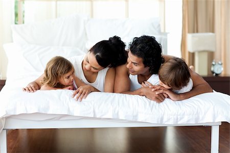simsearch:400-04192370,k - Family relaxing on the bed together at home Stock Photo - Budget Royalty-Free & Subscription, Code: 400-04193399