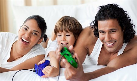 simsearch:400-04157519,k - Happy parents and son playing video games at home Stock Photo - Budget Royalty-Free & Subscription, Code: 400-04193413