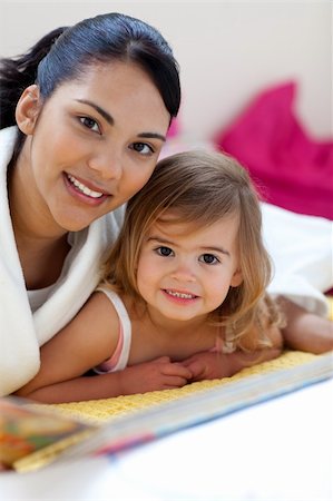 simsearch:400-05749644,k - Close-up of a beautiful little girl and her mother reading a book in the bedroom Stock Photo - Budget Royalty-Free & Subscription, Code: 400-04193423