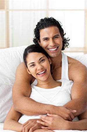 simsearch:400-04150404,k - Attractive man hugging his wife lying on the bed. Concept of love. Stock Photo - Budget Royalty-Free & Subscription, Code: 400-04193447