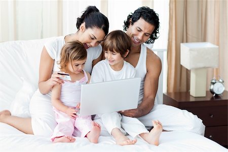 Young family using a credit card to shop online at home Stock Photo - Budget Royalty-Free & Subscription, Code: 400-04193442