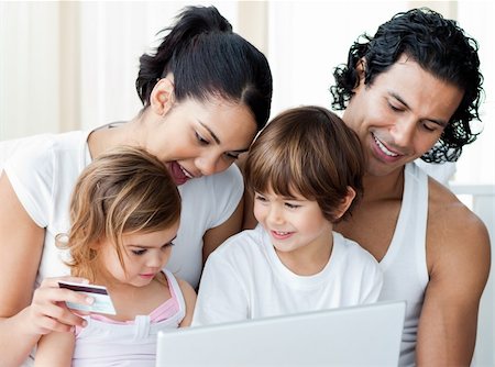 Close-up of a family shopping online at home Stock Photo - Budget Royalty-Free & Subscription, Code: 400-04193443