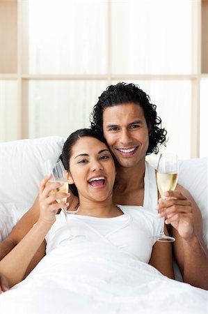 simsearch:400-04150404,k - Happy young lovers drinking Champagne on the bed Stock Photo - Budget Royalty-Free & Subscription, Code: 400-04193456