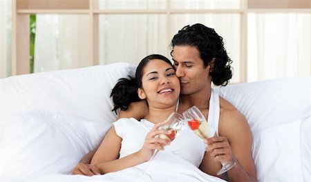 simsearch:400-04150404,k - Lover kissing his wife while toasting with Champagne on the bed Stock Photo - Budget Royalty-Free & Subscription, Code: 400-04193459
