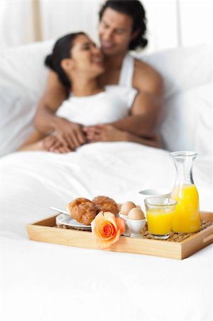 Smiling lovers having breakfast on the bed together Stock Photo - Budget Royalty-Free & Subscription, Code: 400-04193450