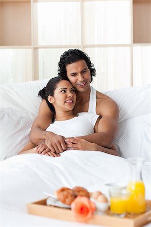 Young lovers having breakfast lying on the bed Stock Photo - Budget Royalty-Free & Subscription, Code: 400-04193452