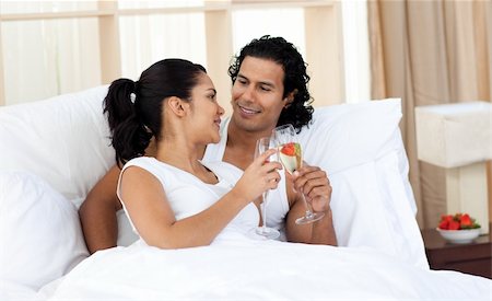 simsearch:400-04326193,k - Portrait of a loving couple sitting on bed at home Stock Photo - Budget Royalty-Free & Subscription, Code: 400-04193460