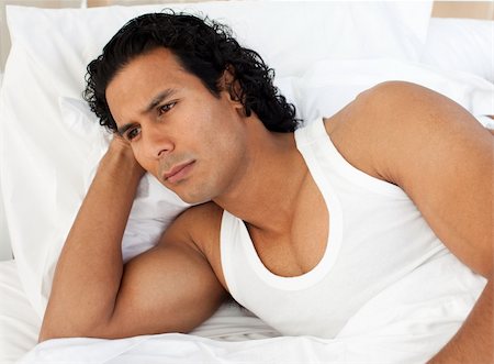 simsearch:400-05739935,k - Angry man lying in the bed after having a row with his wife Stock Photo - Budget Royalty-Free & Subscription, Code: 400-04193475
