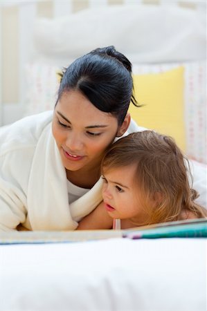 simsearch:400-05751566,k - Attentive mother reading with her daughter lying on a bed Stock Photo - Budget Royalty-Free & Subscription, Code: 400-04193490
