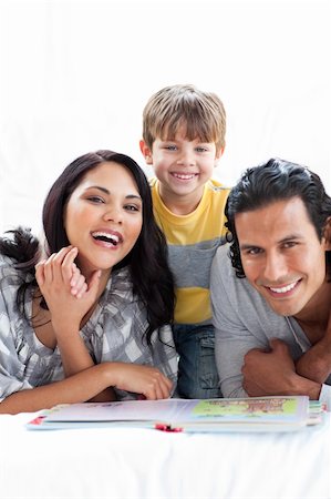 simsearch:400-04193532,k - Jolly family reading book together lying on the floor Stock Photo - Budget Royalty-Free & Subscription, Code: 400-04193534