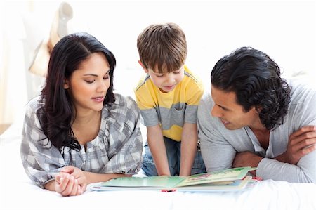 simsearch:400-05749645,k - Affectionate family reading book together lying on the floor Stock Photo - Budget Royalty-Free & Subscription, Code: 400-04193531