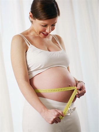 simsearch:649-07437409,k - cropped view of mid adult italian woman measuring waist and smiling. Vertical shape, copy space Stock Photo - Budget Royalty-Free & Subscription, Code: 400-04193854