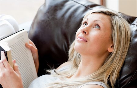simsearch:400-05716909,k - Charming woman reading a book lying on a sofa at home Stock Photo - Budget Royalty-Free & Subscription, Code: 400-04204112