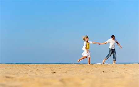 simsearch:400-04702706,k - Happy, fresh young couple enjoy a day on the beach together Stockbilder - Microstock & Abonnement, Bildnummer: 400-04204244