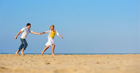 simsearch:400-04702706,k - Happy, fresh young couple enjoy a day on the beach together Stockbilder - Microstock & Abonnement, Bildnummer: 400-04204245