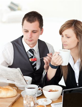 simsearch:400-05741872,k - Young couple of business people reading a newspaper while having breakfast at home Stock Photo - Budget Royalty-Free & Subscription, Code: 400-04204914