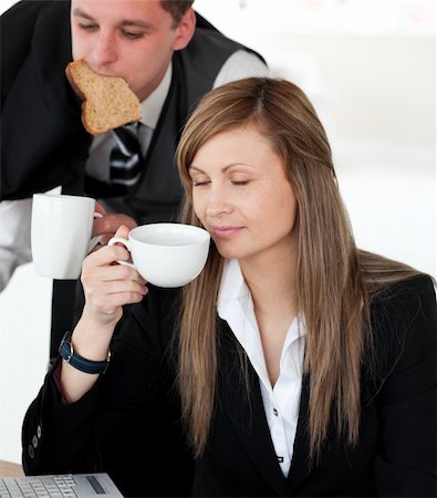 simsearch:400-04209411,k - Pretty businesswoman enjoy her coffee while her husband hurry up in the morning Fotografie stock - Microstock e Abbonamento, Codice: 400-04204926