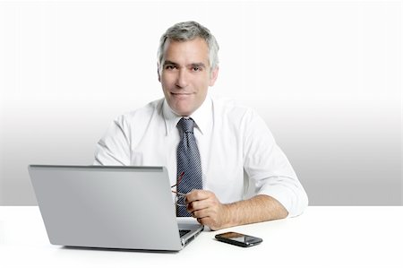simsearch:400-04204942,k - businessman senior gray hair working laptop computer white desk background Stock Photo - Budget Royalty-Free & Subscription, Code: 400-04204940