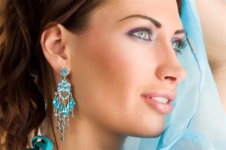 scarf curly woman - close up portrairt of a pretty brunette with blue-sky earring playing to hide her face with a summer headscarf Stock Photo - Budget Royalty-Free & Subscription, Code: 400-04205043