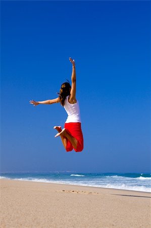 simsearch:400-06077546,k - Beautiful young woman jumping on  the beach Stockbilder - Microstock & Abonnement, Bildnummer: 400-04205208