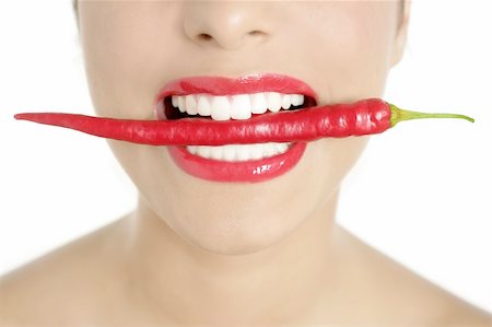 simsearch:400-07899696,k - Beautiful woman teeth eating red hot chili pepper Photographie de stock - Aubaine LD & Abonnement, Code: 400-04205456